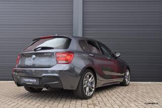BMW 1-SERIE M135i xDrive High Executive | Schuifdak | HK | Camera | Navi Pro | 5-deurs