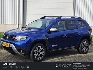 Dacia DUSTER 1.3 TCe 130 Journey / Levering in overleg / Achteruitrijcamera / Apple Car Play & Android Auto / Cruise control / DAB / Dakrails / Automatische airco / Dode hoek detectie / Lichtmetalen velgen 17" / Navigatiesysteem / Parkeersensoren achter